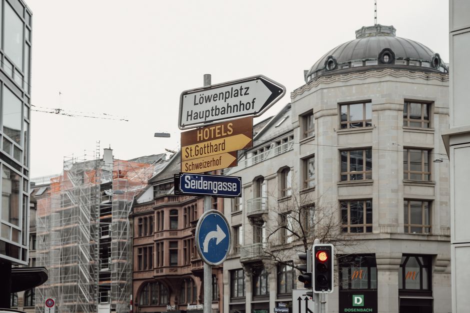 Explore Zurich's urban charm with detailed signage and architecture in this city scene.