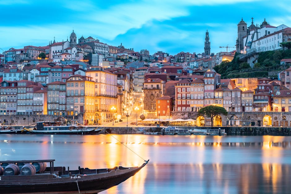 Discover Porto's illuminated cityscape and reflections on the Douro River at twilight.
