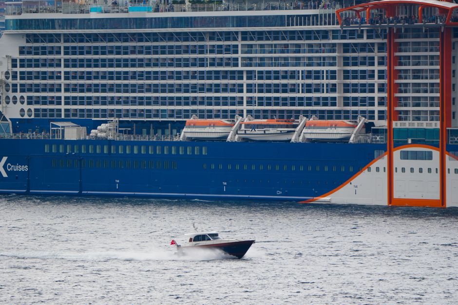 A large cruise ship and a speedboat navigating the waters of Istanbul, Türkiye.