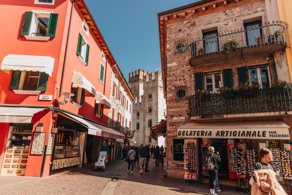 Captivating view of a vibrant Italian street with a gelateria, capturing the essence of historic charm and architectural beauty.