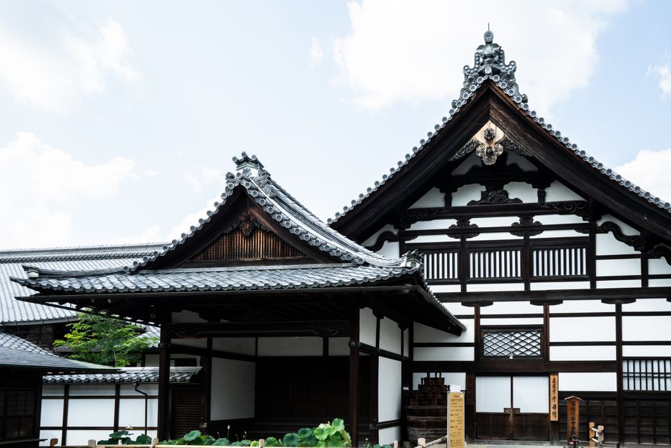 Classic Japanese wooden temple with ornate roof detail in Kyoto, Japan.