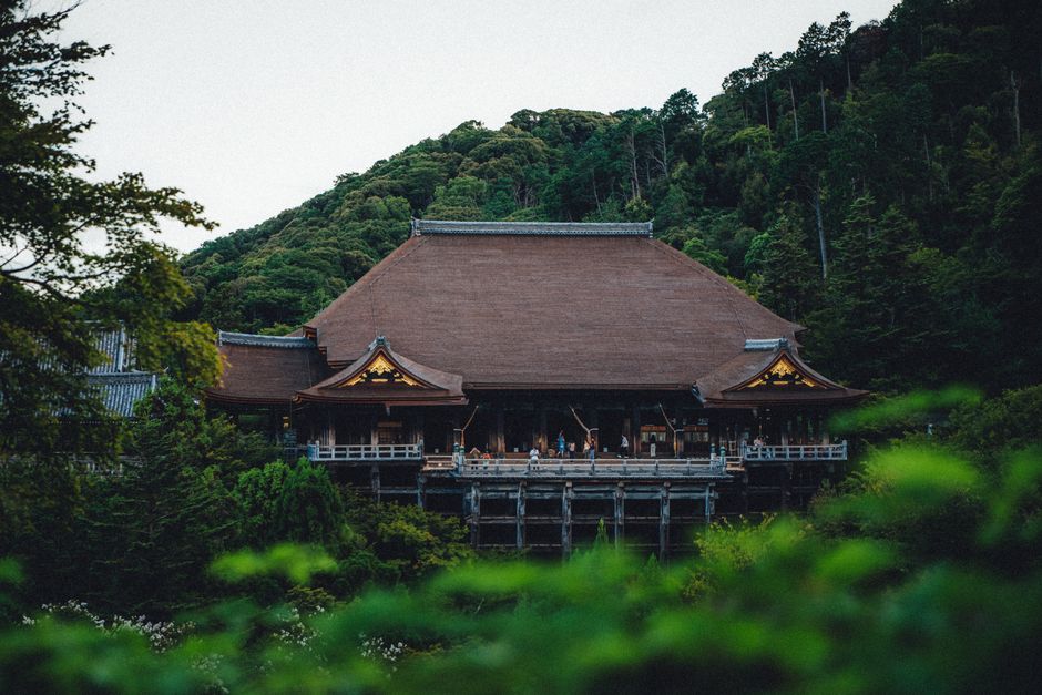 View of Kiyomizu-dera Temple surrounded by lush greenery during the daytime.