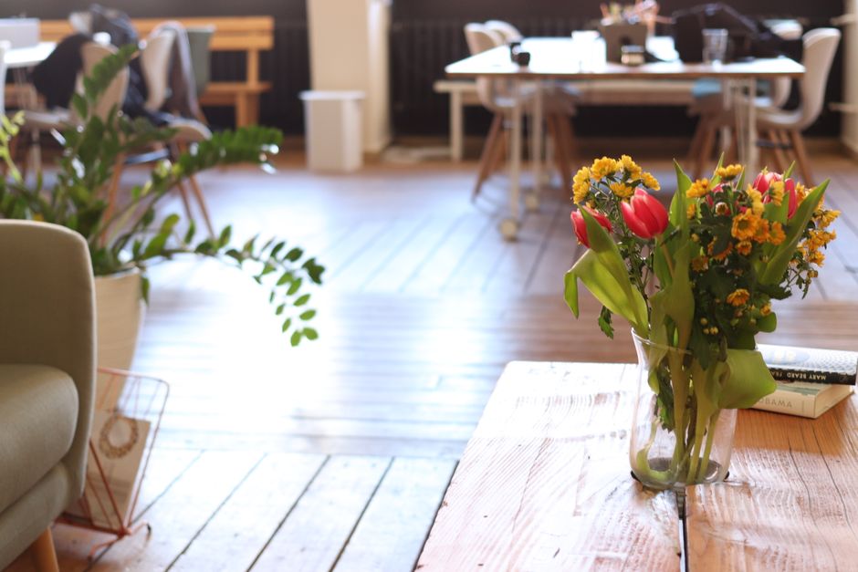 Fresh flowers brighten a modern industrial office, creating a vibrant workspace.