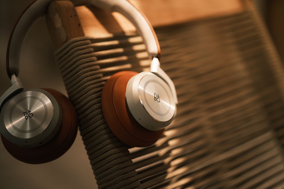 Stylish headphones resting on a wooden chair, showcasing premium design and comfort.