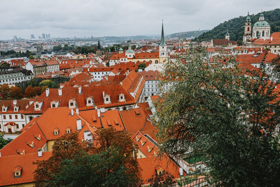A panoramic view of Prague's old town featuring iconic red rooftops and historic architecture.