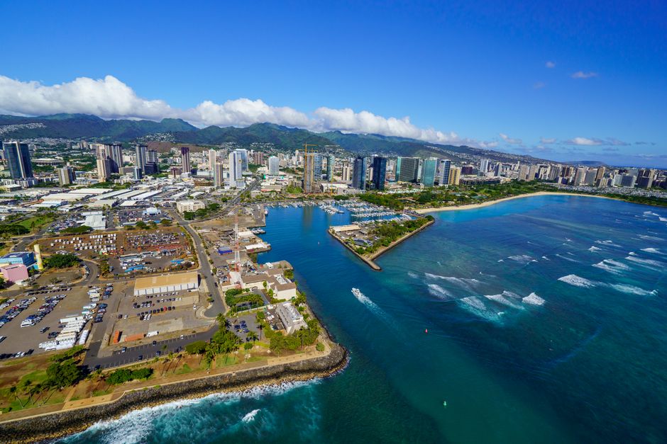 Stunning aerial view of Honolulu's coastline showcasing vibrant cityscape and clear blue waters.