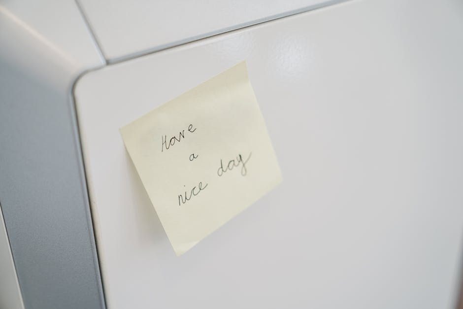 A close-up of a sticky note with 'Have a nice day' on a white surface, conveying positivity.